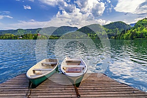 Iconic Bled scenery. Boats at lake Bled, Slovenia, Europe. Wooden boats with Pilgrimage Church of the Assumption of Maria on