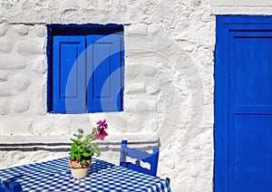 Iconic blue table with wooden chairs , Greece