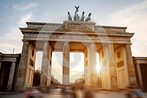 The iconic Brandenburg Gate in Berlin against the backdrop of a soft sunset sky photo