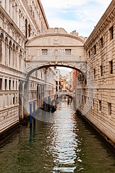 Iconic Bridge of Sighs over a canal with gondolas. Venice, Italy.