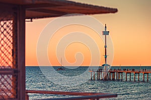 Brighton Jetty with people at sunset