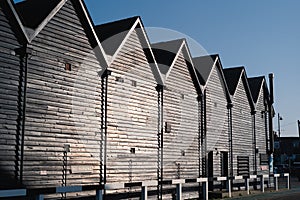 Iconic fishermen huts in black wood in Whitstable harbour, Kent, Uk