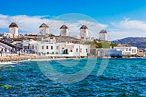 The iconic Mykonos windmills in front of the blu sea