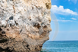 The iconic natural rock formation called The face in Praia da Marinha in Algarve, Portugal, Europe view from popular boat cave