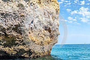 The iconic natural rock formation called The face in Praia da Marinha in Algarve, Portugal, Europe view from popular boat cave