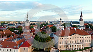 Iconic panning aerial view of Tallinn Old Town and Toompea hill on a sunny summer evening, Estonia