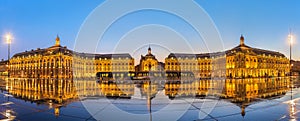 Iconic panorama of Place de la Bourse with tram and water mirror fountain in Bordeaux, France
