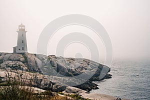 Iconic Peggy's Cove Lighthouse on a foggy day, Nova Scotia, Canada