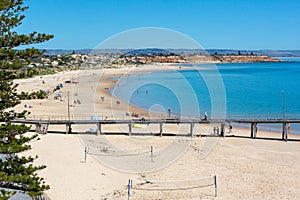 The iconic port noarlunga jetty with people on the beach on a hot day in South Australia on November 2 2020