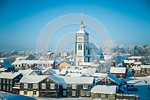 An iconic Roros church in a morning light. Beautiful winter landscape of a small Norwegian town in morning.