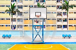 Iconic shot of Hong Kong basketball court with palms and colorful estate building