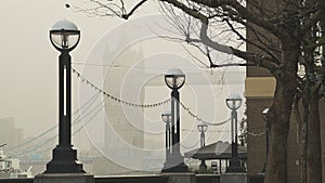 Iconic Tower Bridge in London with orange misty sunrise in mist and fog in atmospheric day one of Co