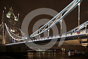 Iconic Tower Bridge seen at night, linking London.