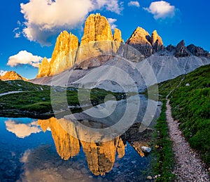 Iconic Tre Cime peaks from Tre Cime di Lavaredo Loop trail at sunset , Italy