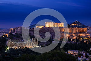 Iconic view of Acropolis hill in Athens, Greece at night. Delicate lights of Parthenon and Odeon theater. UNESCO world photo