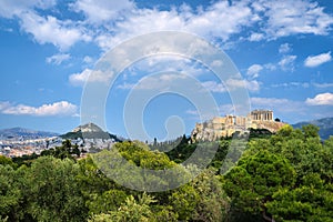 Iconic view of Acropolis hill and Lycabettus hill in background in Athens, Greece from Pnyx hill in summer daylight with