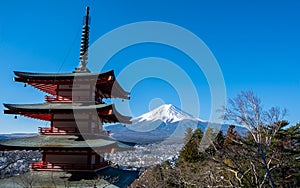 The iconic view of Mount Fuji with the red Chureito pagoda and Fujiyoshida city from Arakurayama sengen park in Yamanashi