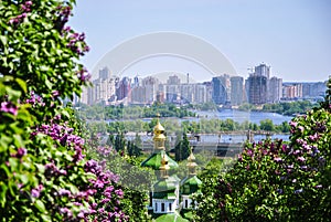 Iconic view to a monastery Vydubitsky and Dnieper River from a botanical garden of Kyiv with blooming lilac