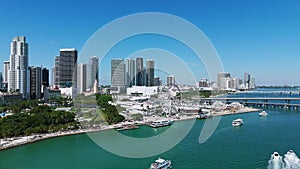 Iconic waterfront Bayview park with luxury high-raised architecture of Miami downtown on background. White yachts