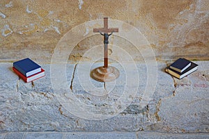 Iconic wooden crucifix with bible & hymn books