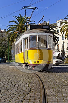 Iconic 100 year old Lisbon yellow tram in Campo das Cebolas photo