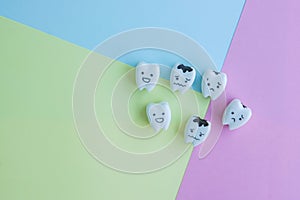 Icons of healthy and decayed teeth on pastel background for kid education