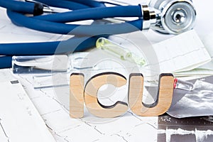 ICU Abbreviation or acronym of intensive care unit in hospital or clinic, special medical unit. Word ICU is on ECG stripes in fore