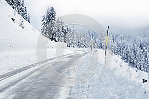 Icy alpine road though on a foggy day