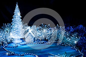 Icy Christmas tree glowing with silver light on a blue background