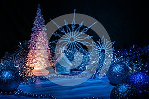 Icy Christmas tree glowing with yellow light on a blue background