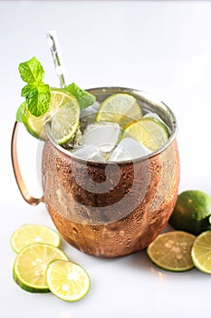 Icy Cold Moscow Mules with Ginger Beer, Lime,  and Vodka, Garnish with Mint Leaf. Isolated on White Background