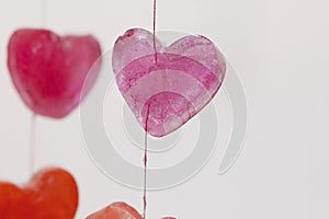 icy colored hearts hanging on branches, valentine`s day card,