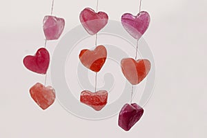 Icy colored hearts hanging on branches, valentine`s day card