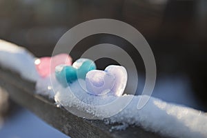 icy colored hearts on snow, valentine`s day card,