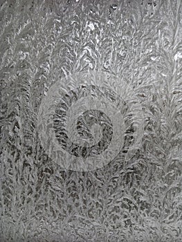 Icy frost patterns on the glass. Severe frost