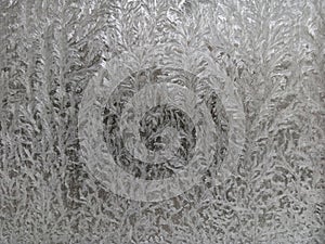 Icy frost patterns on the glass. Severe frost