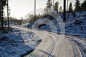 Icy gravel road through a forest