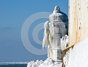 Icy lighthouse at the cold water's edge