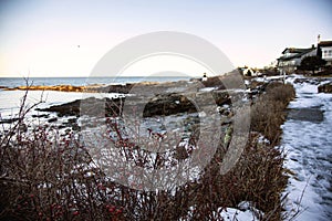 Icy path on Marginal Way path along the rocky coast of Maine in Ogunquit during winter photo