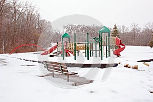 Icy playground and park bench