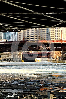 Icy river water chunks under a low-angle view of a frozen Chicago River in January