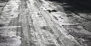 Icy road. Selective focus. Hazard concept ice-crusted ground. Black and white image