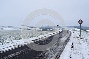 icy road into snowy village Welling in the valley photo