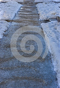 Icy sidewalk and gravel