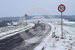 icy small, badly deteriorated country road with speed limit 50 early before the curve into WElling photo