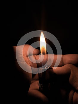 ID 219680577. Fire from gas lighter in hand - Macro photography