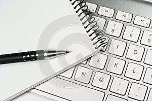 Idea. Computer keyboard. Notepad. Pen
