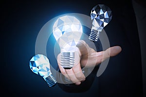 Idea concept. Businessman touching glowing light bulb on virtual screen