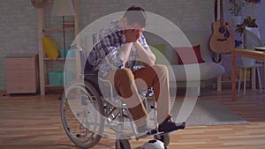 Idea of the concept of ending a sports career,sad disabled man in a wheelchair in with a ball