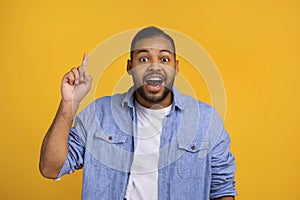 Idea Concept. Excited Black Man Pointing Finger Up And Looking At Camera